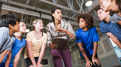 PE coach with students